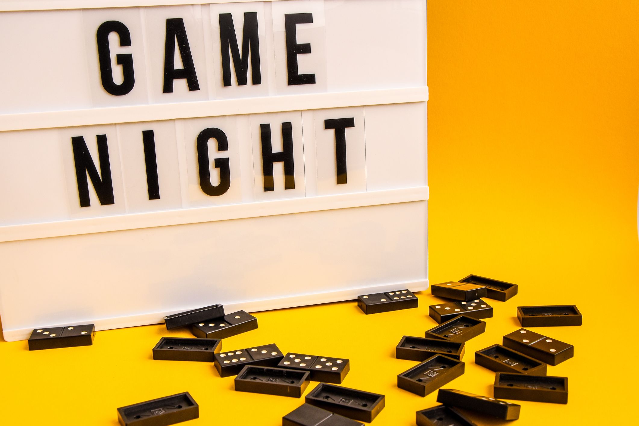 game-night-text-on-lightbox-with-black-dominoes-on-royalty-free-image-1585932331